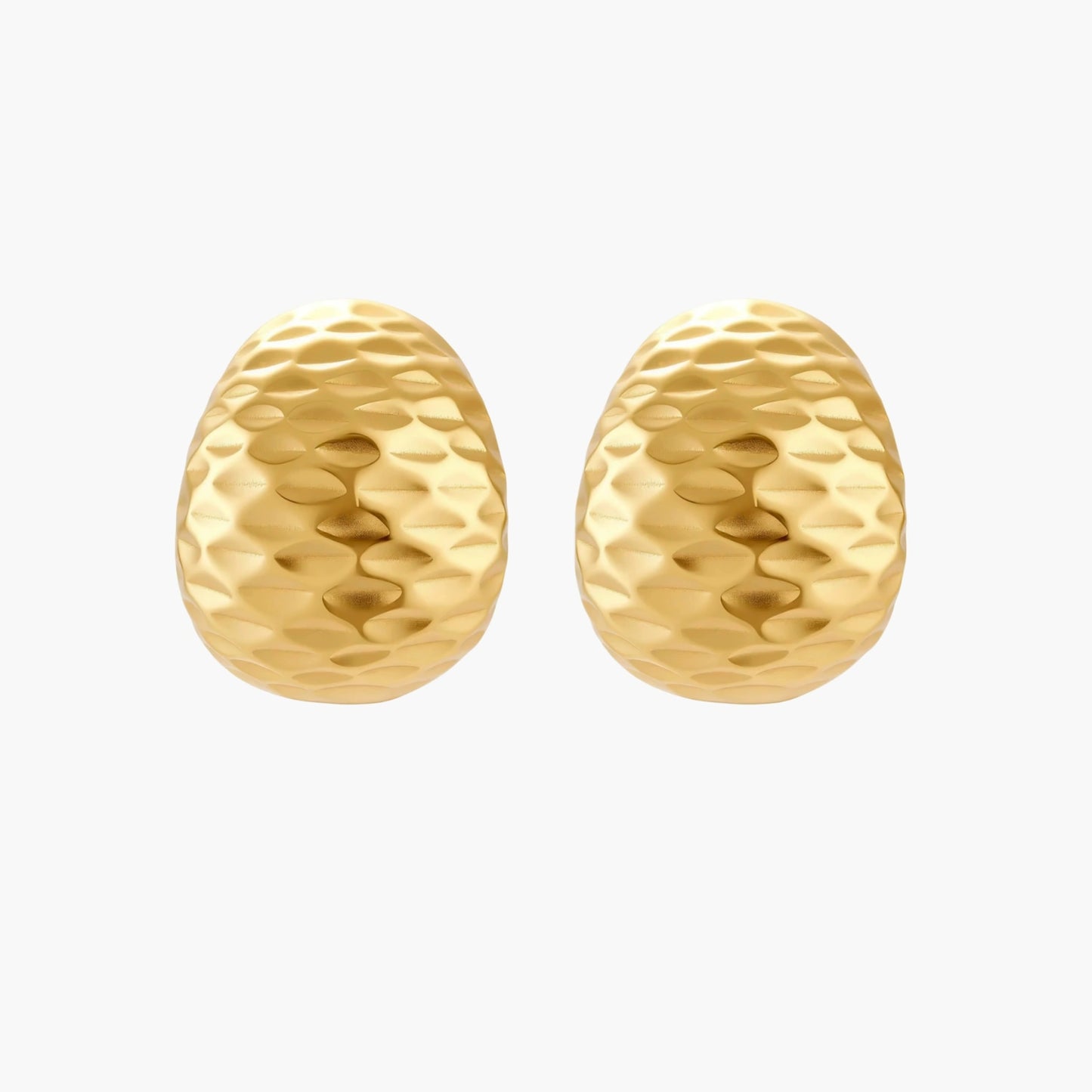 Pair of textured gold-plated sterling silver huggie earrings with dimpled surface finish on cream background.